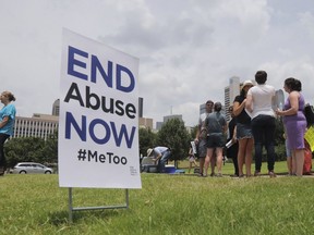 A small group of protesters fighting various forms of abuse within the church engage passersby outside at the Southern Baptist Convention meeting in Dallas, Texas, Tuesday, June 12, 2018.