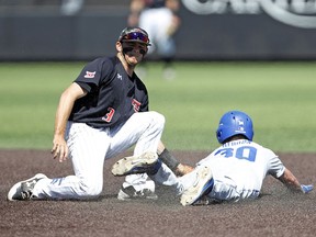 Texas Tech's Michael Davis (3) tags out Duke's Jimmy Herron (30) as he slides into second base during an NCAA college baseball tournament super regional game Monday, June 11, 2018, in Lubbock, Texas.