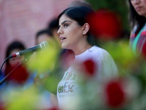 Mariana Ybarra speaks at Saint Mark Catholic Church during a solidarity with migrants vigil, Thursday, June 21, 2018, in El Paso, Texas. President Donald Trump's order ending the policy of separating immigrant families at the border leaves a host of unanswered questions, including what happens to the more than 2,300 children already taken from their parents and where the government will house all the newly detained migrants in a system already bursting at the seams.