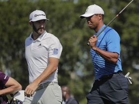 Tiger Woods walks with Dustin Johnson during a practice round for the U.S. Open Golf Championship, Tuesday, June 12, 2018, in Southampton, N.Y.