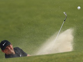 Patrick Reed hits out of a sand trap onto the 16th green during a practice round for the U.S. Open Golf Championship, Monday, June 11, 2018, in Southampton, N.Y.