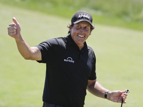 Phil Mickelson reacts after sinking a putt on the 13th hole during the final round of the U.S. Open Golf Championship, Sunday, June 17, 2018, in Southampton, N.Y.