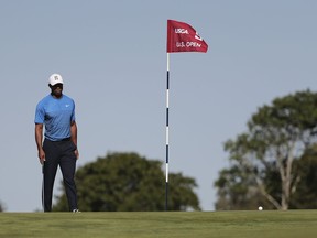 Tiger Woods approaches the pin on the fifth green during a practice round for the U.S. Open Golf Championship, Tuesday, June 12, 2018, in Southampton, N.Y.