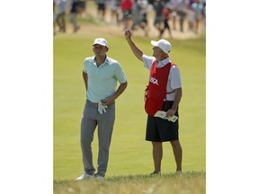 Matt Parziale, left, checks his line to the pin as his father and caddie, Vic Parziale, checks the wind direction during the final round of the U.S. Open Golf Championship, Sunday, June 17, 2018, in Southampton, N.Y.