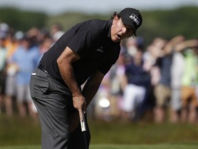 Phil Mickelson reacts after missing a putt on the 14th green during the first round of the U.S. Open Golf Championship, Thursday, June 14, 2018, in Southampton, N.Y.