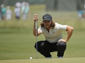 Tommy Fleetwood of England lines up a putt on the third hole during the final round of the U.S. Open Golf Championship, Sunday, June 17, 2018, in Southampton, N.Y.