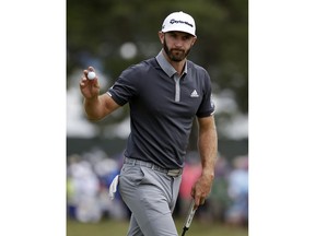 Dustin Johnson reacts after making a putt for birdie on the fourth green during the second round of the U.S. Open Golf Championship, Friday, June 15, 2018, in Southampton, N.Y.