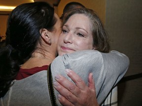 FILE - In this April 5, 2018, file photo, McKenna Denson, right, receives a hug from supporter Jenea Gillespie, left, after speaking with reporters during a news conference in Salt Lake City. Denson, a woman who says a former Mormon missionary leader raped her in the 1980s is accusing church officials of knowing about the man's prior sexual misconduct before he was appointed. Denson's attorneys allege in a court document filed Tuesday, June 13, 2018, that Joseph L. Bishop disclosed to church leaders his "acts of sexual predation" while he was a mission president in Argentina in the late 1970s.