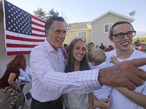 In this Wednesday, June 20, 2018, photo, Mitt Romney poses for photographs during a backyard campaign stop in American Fork, Utah. Romney is flashing his familiar smile at city parks and backyards in Utah's mountains and suburbs this week, making his final pitch after being forced into a Republican primary against a conservative state lawmaker. At stake is being the party's representative to vie for the Senate seat long held by retiring Republican Sen. Orrin Hatch.