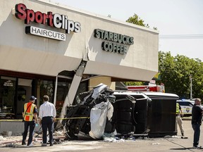 Authorities work at the scene where a pickup truck drove into a Starbucks parking lot and on to an outdoor patio, Friday June 8, 2018, at a Salt Lake City suburban shopping center in Millcreek, Utah. One person is dead and several others injured.