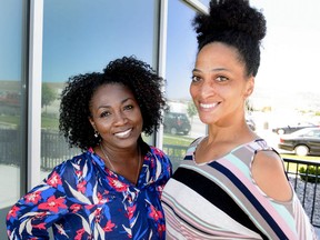 This June 2, 2017, photo, shows Mormon women Tamu Smith, left, and Dr. LaShawn Williams in Lehi, Utah. The Mormon church's celebration Friday night, June 1, 2018, of the 40th anniversary of its reversal of a ban on blacks in the lay priesthood is rekindling discussions about one of the faith's most sensitive topics. Williams, an assistant professor in social work at Utah Valley University, would like an apology. "If we preach repentance, we should definitely embody it," she said.