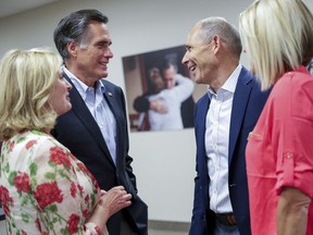 Former GOP presidential nominee Mitt Romney, with his wife Ann, left, and U.S. Rep. John Curtis, with his wife Sue, right, chat after they each claimed victory in their primary elections, Romney for Utah's senate seat and Curtis for the state's 3rd congressional district, in Orem, Utah, on Tuesday, June 26, 2018.