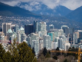 A crane is seen at a condo development under construction as condo and office towers fill the downtown skyline in Vancouver, B.C., on Friday March 30, 2018.