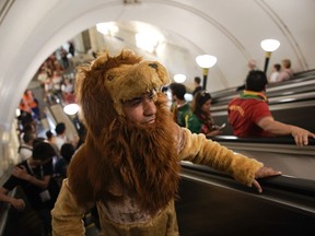 A Morocco fan wearing a lion costume arrives at Sportivnaya metro station to attend the group B match between Portugal and Morocco at the 2018 soccer World Cup in the Luzhniki Stadium in Moscow, Russia, Wednesday, June 20, 2018.