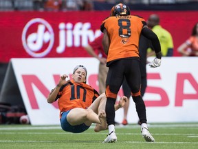 B.C. Lions' Marcell Young (8) knocks down a spectator that ran onto the field of play during the first half of a CFL football game against the Montreal Alouettes in Vancouver, on Saturday June 16, 2018.