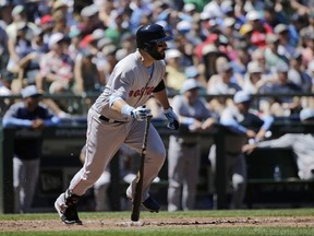 Boston Red Sox's Mitch Moreland hits a two-RBI single against the Seattle Mariners during the third inning of a baseball game, Sunday, June 17, 2018, in Seattle.