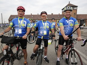 Three-time Tour de France winner Greg LeMond, right, Marcel Zielinski, a Holocaust survivor, center, and Jonathan Ornstein, the director of the Jewish Community Center of Krakow, pose for the media in Oswiecim, Poland, on Friday June 29, 2018. Three-time Tour de France winner Greg LeMond, two Holocaust survivors and dozens of others took part in a symbolic ride from Auschwitz-Birkenau to a Jewish cultural center in Poland to support the renewal of Jewish life. The ride Friday began at the gates of the former Nazi German death camp and ended at the Jewish Community Center of Krakow 55 miles (89 kilometers) away - a place where the Jewish community is growing.