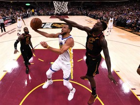 Stephen Curry of the Golden State Warriors goes hard to the basket against defender Jeff Green of the Cleveland Cavaliers for two of his game-high 37 points in Friday's Game 4 of the NBA Finals Friday in Cleveland. The Warriors completed a four-game sweep with a 108-85 victory, giving them back-to-back NBA titles and three in the past four years.