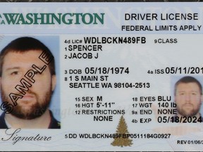 A sample copy of a Washington drivers license is shown at the Washington state Dept. of Licensing office in Lacey, Wash., Friday, June 22, 2018. Some Washington licenses and identification cards will soon be marked with the words "federal limits apply" as the state moves to comply with a federal law that increased rules for identification needed at airports and federal facilities.