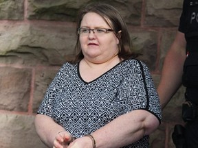 Elizabeth Wettlaufer is escorted by police from the courthouse in Woodstock, Ont., on June 26, 2017.