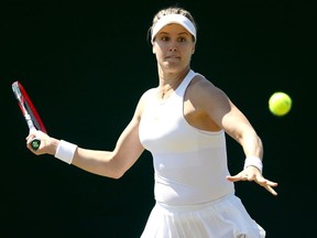 In this June 27 file photo, Eugenie Bouchard returns a shot to Karolina Muchova in a qualifying match at Wimbledon.