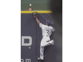 Milwaukee Brewers' Eric Thames can't catch a two-run home run hit by St. Louis Cardinals' Yadier Molina during the sixth inning of a baseball game Saturday, June 23, 2018, in Milwaukee.