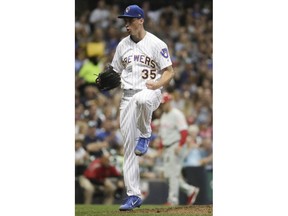 Milwaukee Brewers starting pitcher Brent Suter reacts after Philadelphia Phillies' Aaron Altherr grounded into a double play during the seventh inning of a baseball game Friday, June 15, 2018, in Milwaukee.