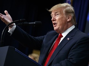 In this June 22, 2018 photo, President Donald Trump speaks about immigration alongside family members affected by crime committed by undocumented immigrants, at the South Court Auditorium on the White House complex in Washington. Trump claims that America's immigration problems could be solved by "simply" stopping them at the border and turning them away without access to a judge. But it's nowhere near simple _ or legal.