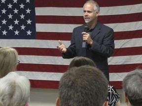 FILE - In this July 25, 2016, file photo, then-Rep. Tim Huelskamp, R-Kan., speaks during a campaign town hall meeting at the headquarters of Patriot Outfitters, which sells firearms, accessories and hunting and military gear in St. Marys, Kan. The Republican newcomers stunned Washington in the 2010 midterm election, sweeping into the House majority with bold and boisterous promises to cut taxes, slash spending and rollback what many viewed as Barack Obama's executive overreach of the federal of government. Huelskamp said the "most egregious failure" was the GOP's inability to undo the Affordable Care Act, or Obamacare.