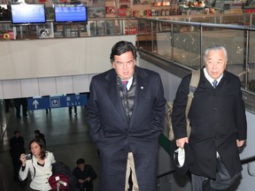 FILE - In this Dec. 20, 2010, file photo, released by China's Xinhua news agency, New Mexico Gov. Bill Richardson, center, arrives at Pyongyang international airport in Pyongyang, capital of North Korea.
