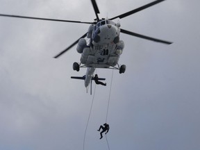 FILE - In this Aug. 21, 2017, file photo, South Korean police officers rappel down from a helicopter during an anti-terror drill as part of Ulchi Freedom Guardian exercise, in Goyang, South Korea. The Pentagon says it has formally suspended a major military exercise, Ulchi Freedom Guardian, planned for August 2017 with South Korea, a much-anticipated move stemming from President Donald Trump's nuclear summit with North Korean leader Kim Jong Un.