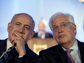 FILE - In this May 21, 2017, file photo, Israeli Prime Minister Benjamin Netanyahu, left and David Friedman, right, the new United States Ambassador to Israel attend a ceremony celebrating the 50th anniversary of the liberation and unification of Jerusalem, in front of the walls of the Old City of Jerusalem. AP sources say President Donald Trump is considering giving Friedman more authority over the U.S. outpost that handles Palestinian affairs, a shift likely to further dampen Palestinian hopes for an independent state.