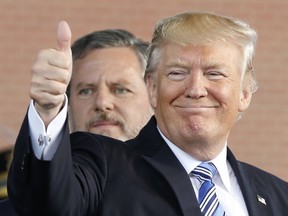 FILE - In this May 13, 2017 file photo, President Donald Trump, right, gives a thumbs up as Liberty University president, Jerry Falwell Jr., left, watches during of commencement ceremonies at the school in Lynchburg, Va.  For evangelical Christian icons like Jerry Falwell Jr., a Supreme Court that opposes abortion rights is their political holy grail. The Liberty University president is among many religious conservatives who suspect the Supreme Court vacancy President Donald Trump fills in the coming months will ultimately lead to the reversal of the landmark abortion case Roe v. Wade.