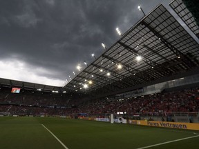 Dark clouds move over the stadium as heavy rain and hail delay the start of a friendly soccer match between Austria and Germany in Klagenfurt, Austria, Saturday, June 2, 2018.