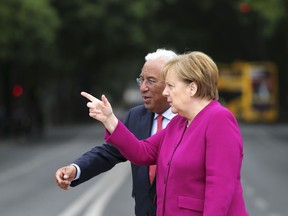 German Chancellor Angela Merkel, right, walks with Portuguese Prime Minister Antonio Costa before their meeting at the Foz palace in Lisbon, Thursday, May 31, 2018. Merkel is in Portugal for a 24-hour official visit during which she will discuss the European Union's future with local officials.