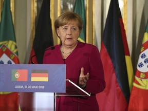 German Chancellor Angela Merkel speaks during a news conference with Portuguese Prime Minister Antonio Costa following their meeting at the Foz palace in Lisbon, Thursday, May 31, 2018. Merkel is in Portugal for a 24-hour official visit during which she will discuss the European Union's future with local officials.