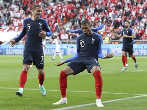 France's Kylian Mbappe, left celebrates with =teammate France's Antoine Griezmann after scoring the opening goal of the game during the group C match between France and Peru at the 2018 soccer World Cup in the Yekaterinburg Arena in Yekaterinburg, Russia, Thursday, June 21, 2018.