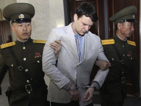 FILE - In this March 16, 2016, file photo, American student Otto Warmbier, center, is escorted at the Supreme Court in Pyongyang, North Korea. President Donald Trump had previously condemned the cruelty of North Korea's government, but after his historic summit on Tuesday with North Korean leader Kim Jong Un, Trump seemed to play down the severity of human rights violations in North Korea.