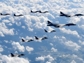 FILE - In this Sept. 18, 2017, file photo provided by South Korea Defense Ministry, U.S. Air Force B-1B bombers, F-35B stealth fighter jets and South Korean F-15K fighter jets fly over the Korean Peninsula during a joint drills. U.S. President Donald Trump promised to end "war games" with South Korea, calling them provocative, after meeting North Korean leader Kim Jong Un on June 12, 2018. His announcement appeared to catch both South Korea and the Pentagon by surprise. (South Korea Defense Ministry via AP, File)