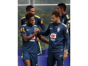 Brazil's Neymar shakes hands with Fred during the training session at Enfield Training Ground, London, Britain, Tuesday June 5, 2018.