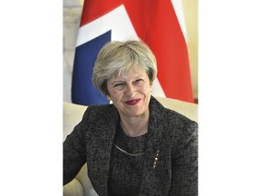 Britain's Prime Minister Theresa May smiles during her meeting with Greece's Prime Minister Alexis Tsipras at 10 Downing Street, in London, Tuesday, June 26, 2018.