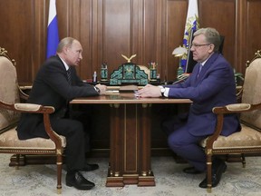 Russian President Vladimir Putin, left, speaks to Russia's former finance minister Alexei Kudrin, the head of the chair of the Audit Chamber in the Kremlin in Moscow, Russia, Monday, June 4, 2018.