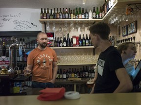 FILE - In this Friday, May 22, 2015 file photo, Stanislav Obraztsov, left, speaks to his colleagues at his craft beer bar in Moscow, Russia. For many fans of food and football, a World Cup in Russia is unfamiliar territory. Russian cuisine has a reputation for being stodgy, unimaginative fare. While that may have been true for many in the days of Soviet supply shortages, a new generation of Russian in the World Cup's host cities mix together influences from across Europe and Asia.