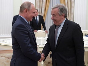 Russian President Vladimir Putin, left, shakes hands with UN Secretary General Antonio Guterres during their meeting in the Kremlin in Moscow, Russia, Wednesday, June 20, 2018.