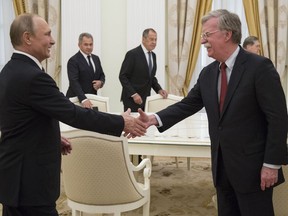 Russian President Vladimir Putin, left, shakes hands with U.S. National security adviser John Bolton during their meeting in the Kremlin in Moscow, Russia, Wednesday, June 27, 2018. U.S. President Donald Trump's national security adviser is due in Moscow Wednesday to lay the groundwork for a possible U.S.-Russia summit.