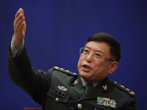 FILE - In this March 8, 2018 file photo, Vice President of China's Academy of Military Sciences, Lt. Gen. He Lei gestures as he speaks during a press conference on the sidelines of the National People's Congress at the State Council Information Office in Beijing. China has dispatched a low-level military delegation to an annual security conference in Singapore that has dwelled heavily on Chinese activities in the South China Sea.