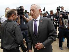 In this Wednesday, June 20, 2018, file photo, U.S. Defense Secretary Jim Mattis, center, steps away after speaking with the media at the Pentagon. U.S. Defense Secretary Jim Mattis, who has accused China of "intimidation and coercion" in the South China Sea, is visiting Beijing as the countries increasingly spar over U.S. arms sales to Taiwan and Beijing's expanding military presence overseas.