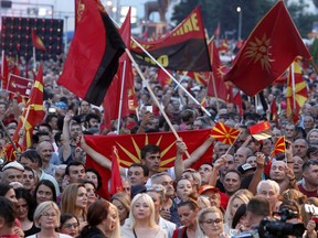 Supporters of the opposition VMRO-DPMNE party wave national, former national flags and party flags during a protest in front of the Government building in Skopje, Macedonia, Saturday, June 2, 2018. Thousands of people gathered Saturday in Skopje on an anti-government protest, organized by the main conservative opposition party.