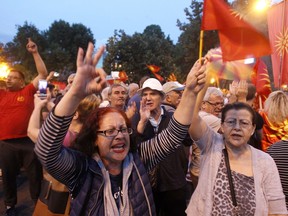 People protest against the change of the country's constitutional name in front of the Parliament building in Skopje, Macedonia, Wednesday, June 13, 2018. A historic deal ending a decades-long dispute between neighbors Greece and Macedonia over the latter's name met with mixed reactions in both countries Wednesday, with some welcoming the agreement and others horrified at what they see as unacceptable concessions.