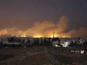 This photo provided Monday, June 25, 2018, by Nabaa Media, a Syrian opposition media outlet, shows smoke rising over buildings that were hit by Syrian government forces bombardment, in Busra al-Harir, in Daraa, southern Syria. Fighting escalated in southern Syria Tuesday with government forces pushing deeper in the southern Daraa province under the cover of airstrikes as residents said they are living in extreme fear and many have fled their homes with the U.N. estimating that 45,000 people have been displaced over the past week. (Nabaa Media, via AP)